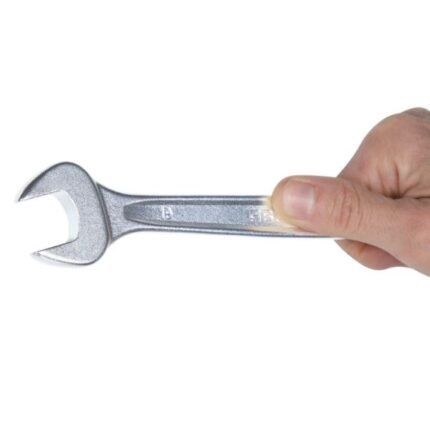 A Beta Tools 7/16 combination wrench held firmly in hand, showing the open-end design and durable chrome finish. Get it at Wrenchers.com