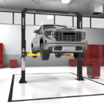 APEX AL10C two post car lift shown in a professional automotive shop bay lifting a full size pickup. A reliable shop lift solution available at