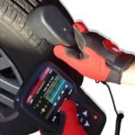 ATEQ TD01 tire tread depth gauge in use measuring tire tread depth with digital readout displayed on the VT56 TPMS service tool