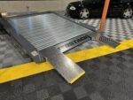 Heavy-duty, lightweight aluminum ramps with 18-inch wide non-slip surface for stable vehicle loading.