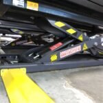 BendPak MDS-6EXT 6,000-lb. mid-rise scissor lift with extended platforms for long-wheelbase and electric vehicles, featuring pneumatic safety locks and cushioned rubber contact blocks.