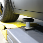 Extended-length BendPak MDS-6EXT mid-rise lift with air-assisted kicker system, durable steel frame, and safety lock bars for servicing modern EVs and long vehicles with confidence.