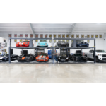 Real-world installation of the BendPak PL-12000DPS parking lift (SKU 5175552) showing how homeowners and collectors can double garage capacity by stacking vehicles vertically without expanding square footage.