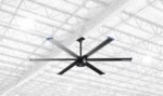 Cool Boss CB-11 HVLS industrial fan with six large aluminum blades shown against a bright warehouse ceiling background for scale and airflow coverage