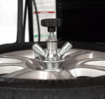 Center clamp wheel holding system on the Hofmann Monty 3550EM-SS securing the wheel through the hub for scratch-free tire service