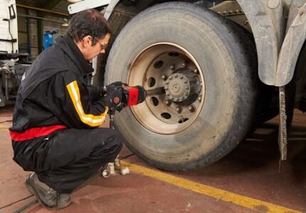 Mechanic using a Chicago Pneumatic 7782-6 heavy-duty impact wrench to remove lug nuts from a truck wheel inside a service bay – Get it at Wrenchers.com today
