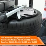 TC184432 mount head installed on a tire changer during bead lifting, showing contact with tire sidewall and rim edge