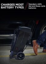 Technician using DSR ProSeries DSR131 charger near a truck, demonstrating professional-grade power and convenience during battery service. Get it at Wrenchers.com