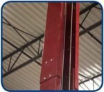 Interior view of a red lift column showing the vertical cable guide channel and factory hardware mounting points