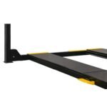 Angled view of four-post lift runways showing low-profile design, yellow safety end caps, and column mounting points