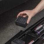 Short dimpled rubber lift block protects pinch welds and frame rails while providing a secure lifting surface