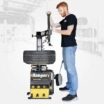 The R745 swing-arm tire changer demonstrated in a shop setting, highlighting its user-friendly design for high-volume tire service operations