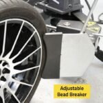 Adjustable bead breaker on the R745 tire changer delivering controlled force to safely separate tire beads from the wheel rim