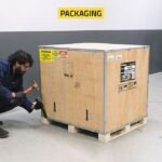 The R745 tire changer packaged in a durable, reinforced wooden crate designed to protect the machine during delivery appointment needs and delivery