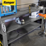 Ranger RWB-2S workbench in a garage setting, displaying tools and equipment stored on its two steel shelves