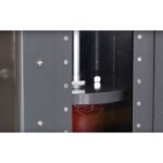 Internal view of a hydraulic oil filter crusher compressing an oil filter inside the steel chamber