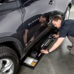 Low-profile QuickJack 6000TL frames slide easily under vehicles for fast setup and safe lifting in home garages.